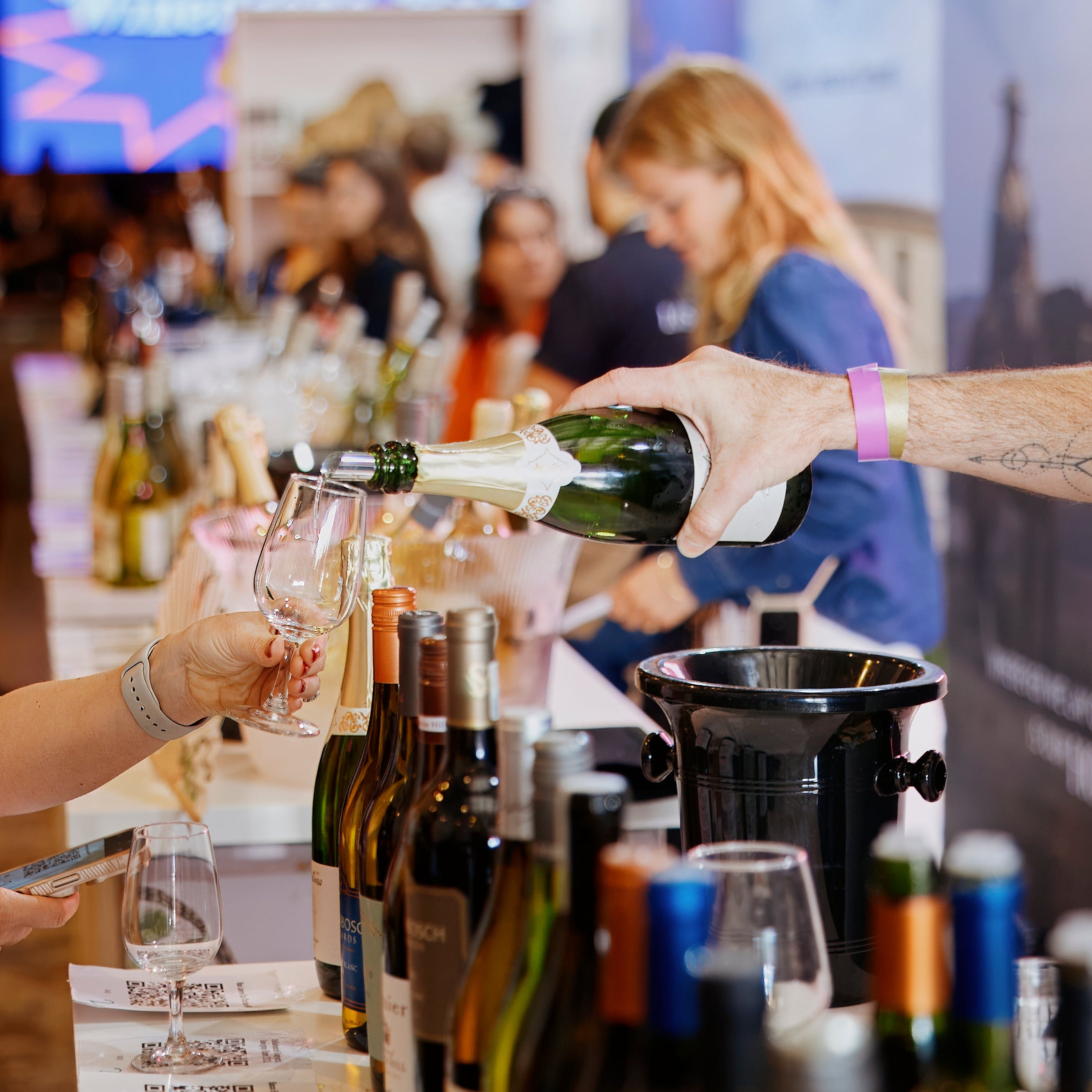 Person pouring wine at at the UKs biggest wine festival - Winedrops Live